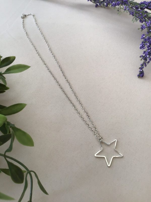 Star pendant on silver coloured necklace