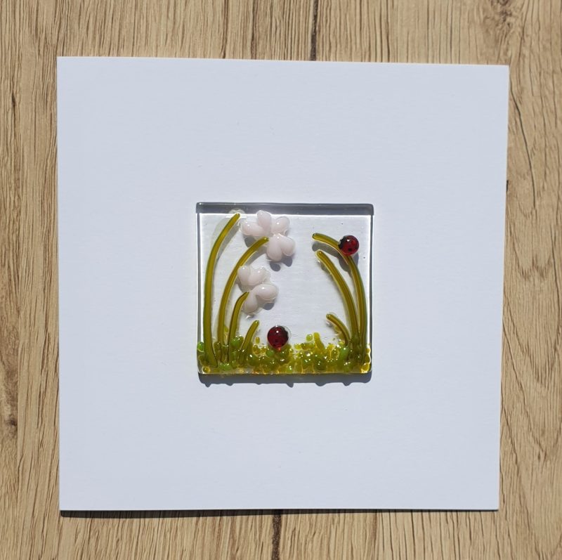 Keepsake fused glass blank card featuring a pair of ladybirds and pink flowers