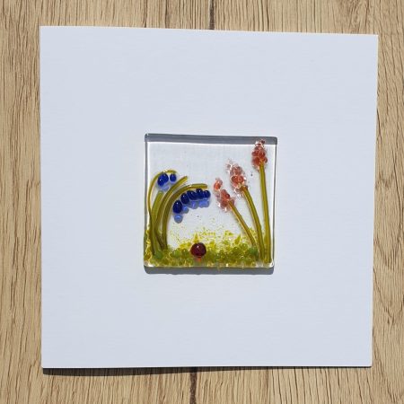 Keepsake fused glass blank card featuring a ladybird with blue bells and coral flowers