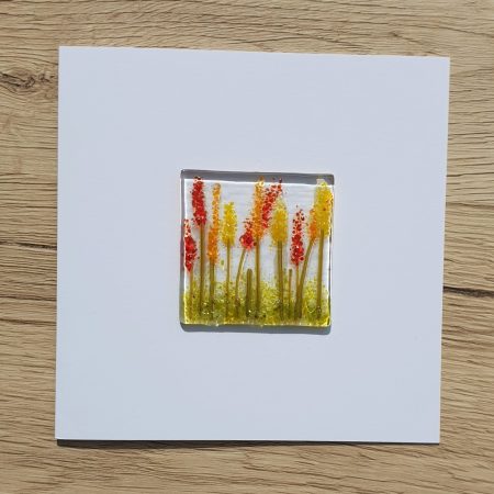 Keepsake fused glass blank card featuring hot red, orange and yellow lupins.