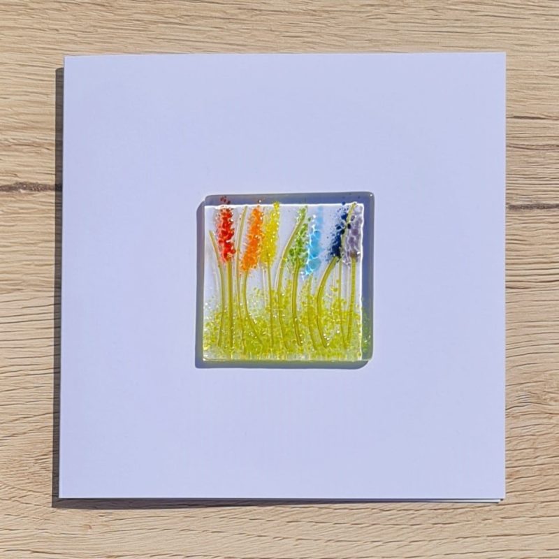 Keepsake fused glass blank card featuring lupins in a rainbow pattern