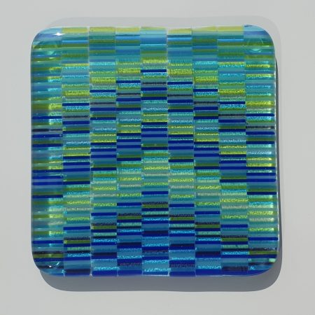 Fused glass full tapestry arrow design coaster in aquamarine, blue and yellow with purple highlights