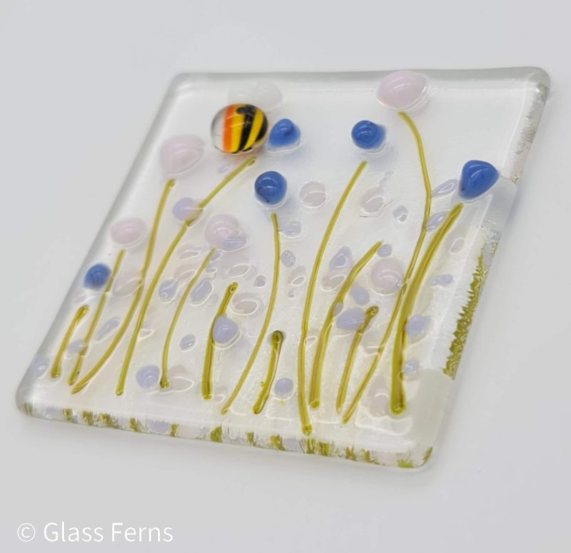 Keepsake fused glass blank card featuring a joyful buzzing bee in delicate pastel flowers