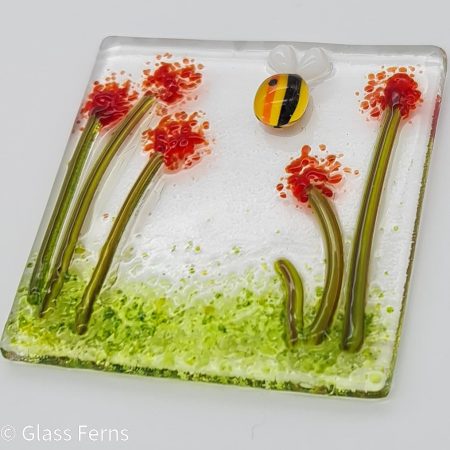 Keepsake fused glass blank card featuring a little buzzing bee in amongst bright red pom-pom flowers