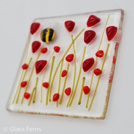 Keepsake fused glass blank card featuring a little bee buzzing in amongst bright red poppies