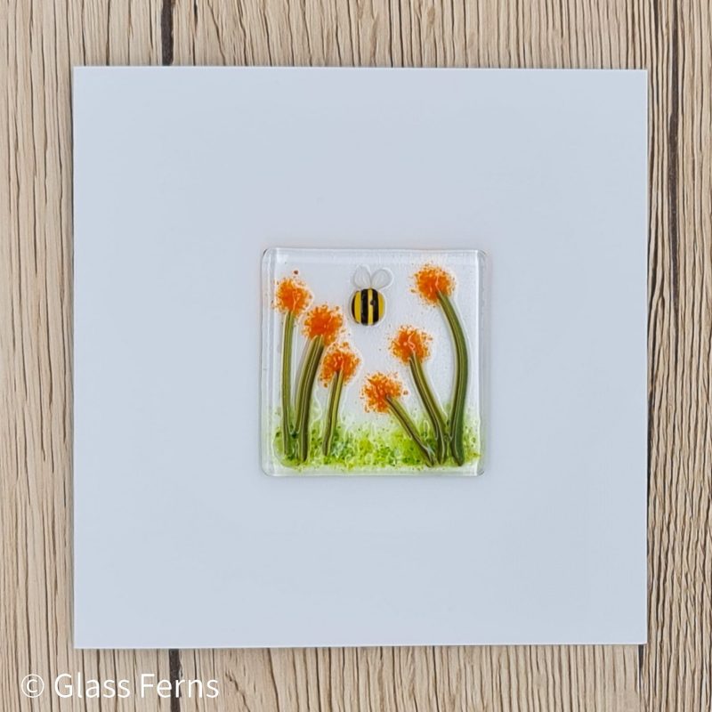Keepsake fused glass blank card featuring a little bee buzzing in amongst orange pom-pom flowers