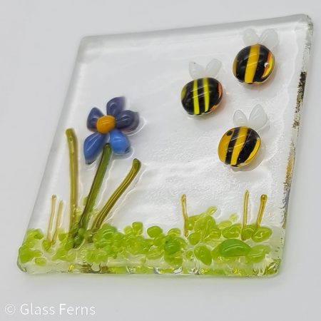 Keepsake fused glass blank card featuring a trio of bees buzzing by a cute purple and blue flower