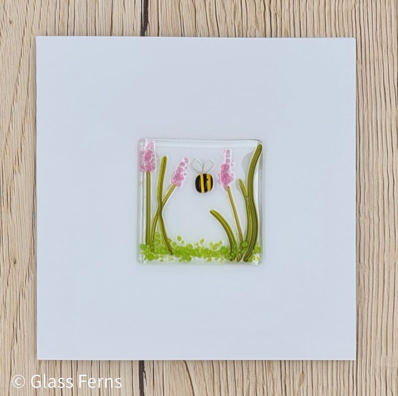 Keepsake fused glass blank card featuring a little bee buzzing in amongst pink flower spikes