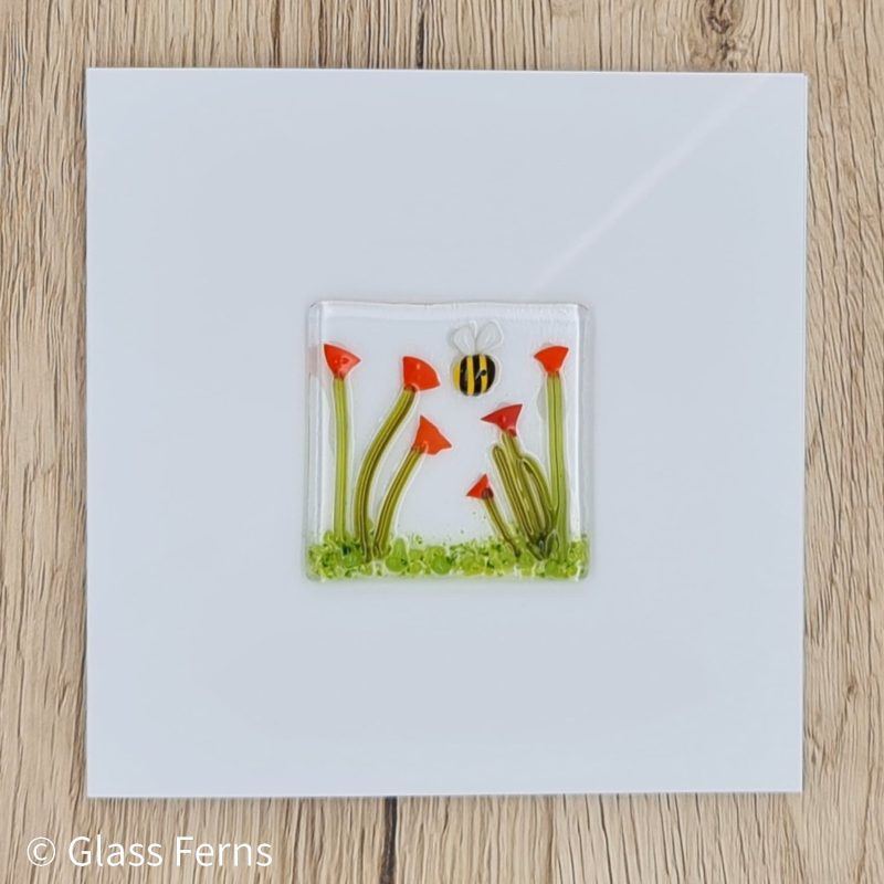 Keepsake fused glass blank card featuring a little bee buzzing in amongst bright orange Poppies