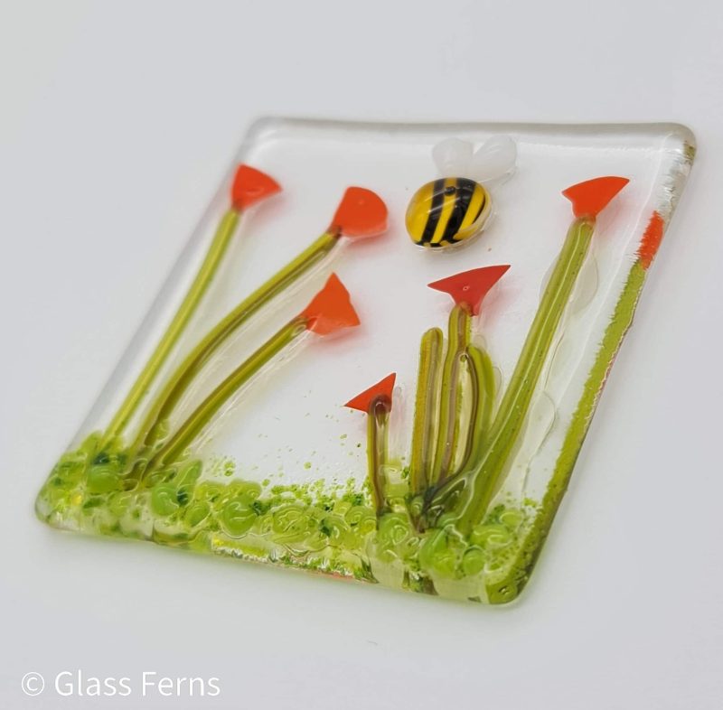 Keepsake fused glass blank card featuring a little bee buzzing in amongst bright orange Poppies
