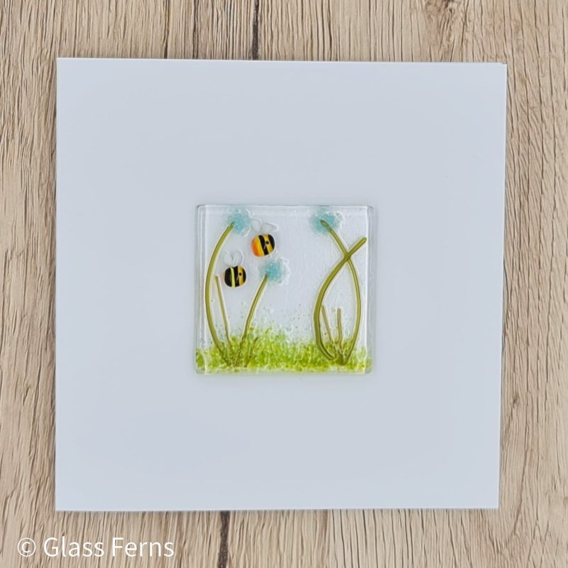 Keepsake fused glass blank card featuring two cute bees in amongst turquoise pom-pom flowers