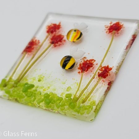 Keepsake fused glass blank card featuring two cute bees in amongst bright red pom-pom flowers