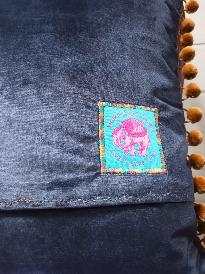 The Camel Velvet Cushion, Tapestry Style Print with Pom-pom Trim.