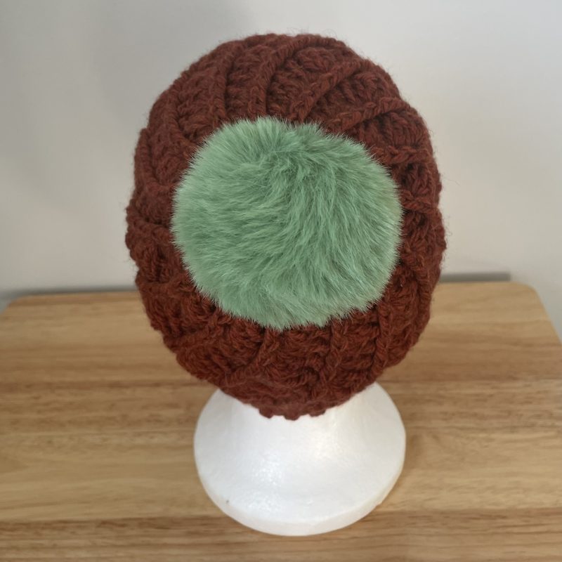 Hand-made crochet hat, brown with a green faux fur bobble