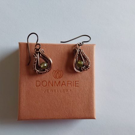 Wire weave earrings with micro-faceted Peridot beads and fitted Niobium hypoallergenic ear wires.