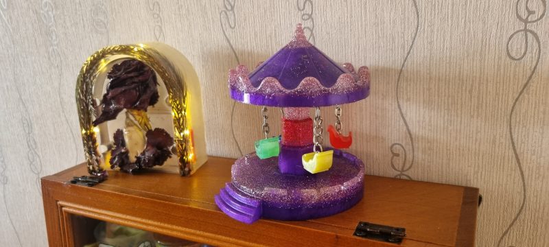 Resin merry-go-round ornament in various colours and textures