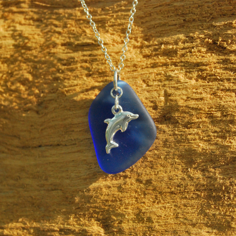 Blue beach glass pendant with silver dolphin charm