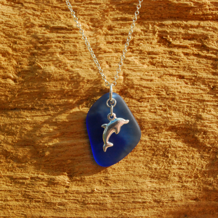 Blue beach glass pendant with silver dolphin charm
