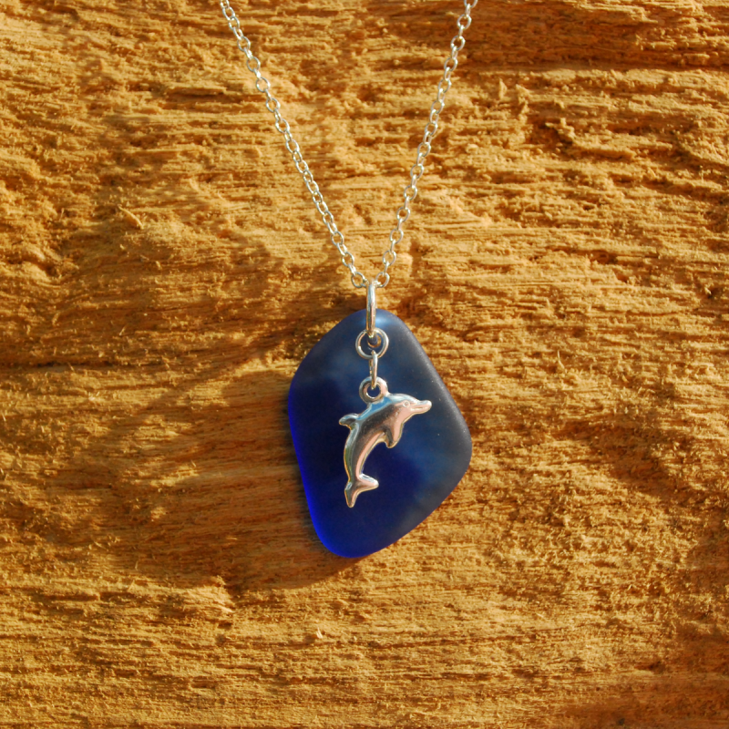 Blue beach glass pendant with silver dolphin charm