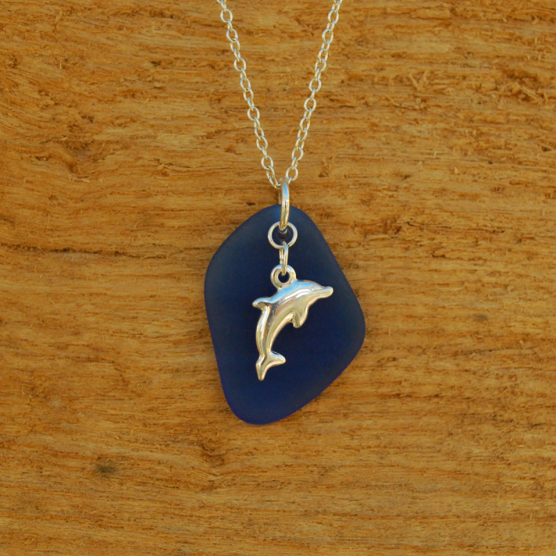 Blue beach glass pendant with silver dolphin charm
