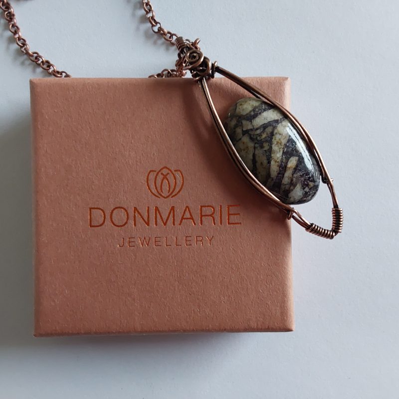 Wire wrapped Flourite in Feldspar cabochon pendant.