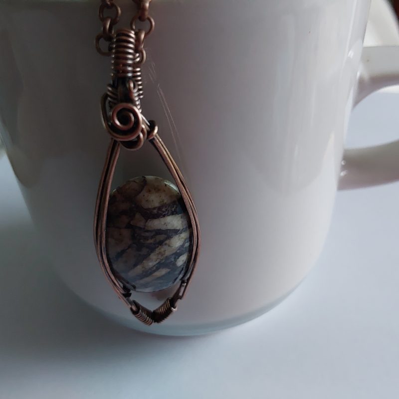 Wire wrapped Flourite in Feldspar cabochon pendant.