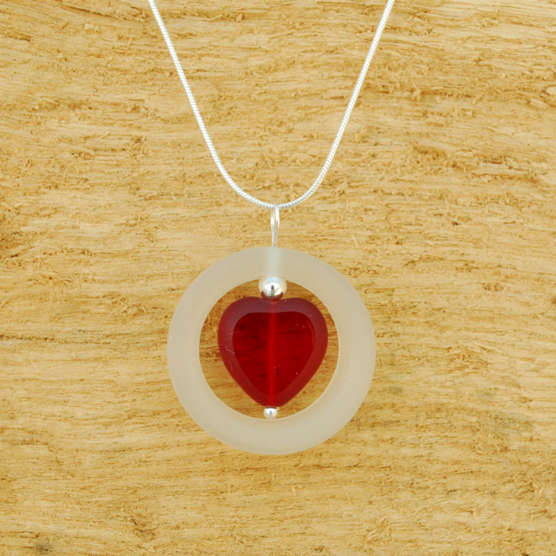 Glass ring with red heart pendant