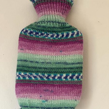 Dinky hot water bottle with hand crafted cover ( yarn design Katie)
