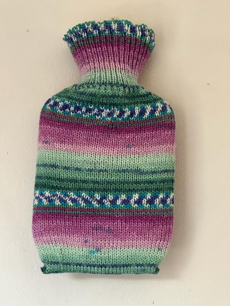 Dinky hot water bottle with hand crafted cover ( yarn design Katie)