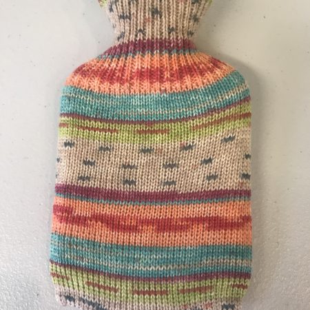 Pocket size dinky hot water bottle with hand crafted cover