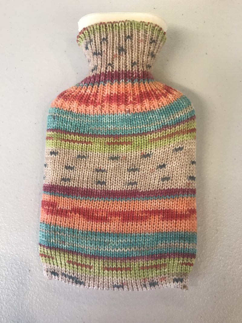 Pocket size dinky hot water bottle with hand crafted cover