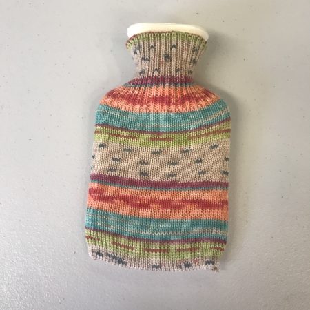 Pocket size dinky hot water bottle with hand crafted cover