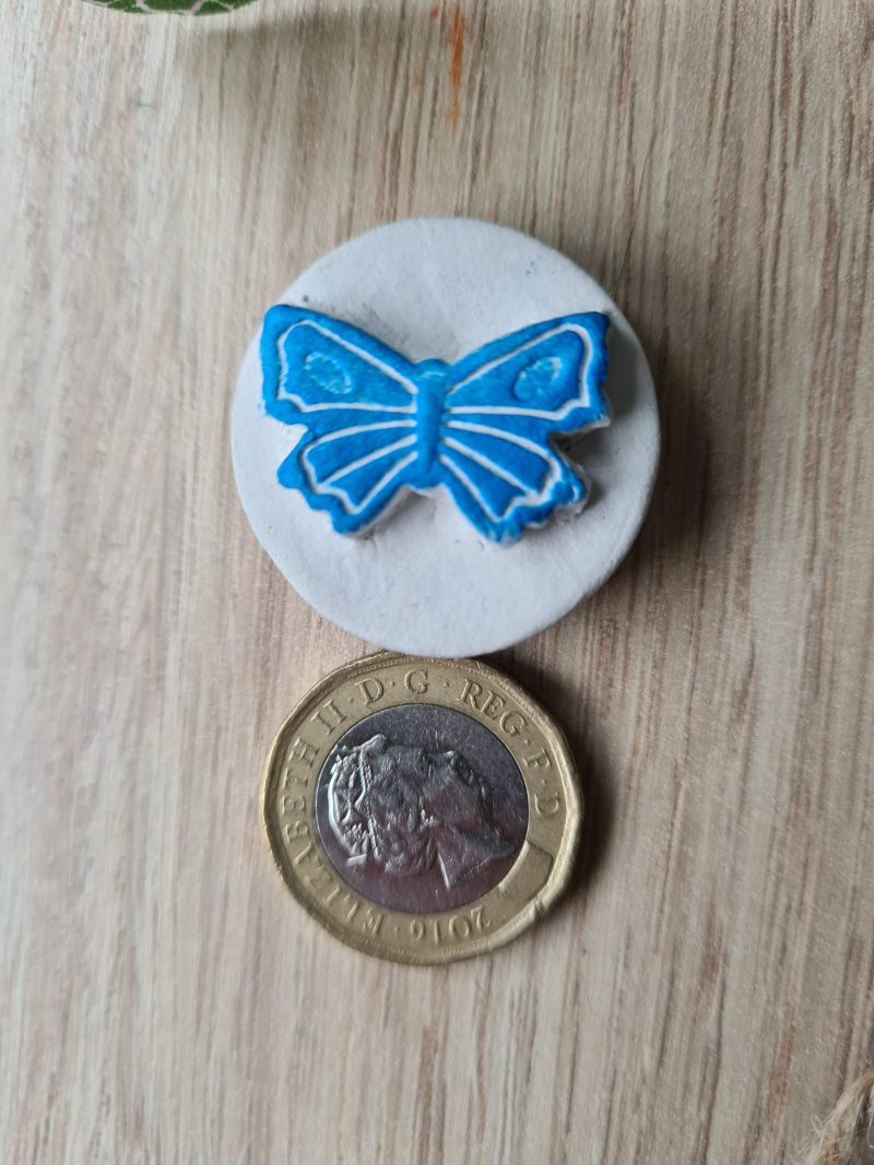 2 Clay butterfly magnets blue and red
