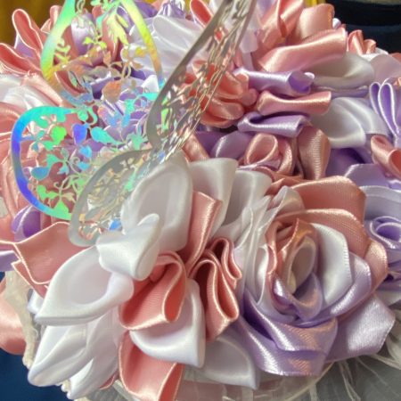 Medium sized round box of hand made ribbon flowers