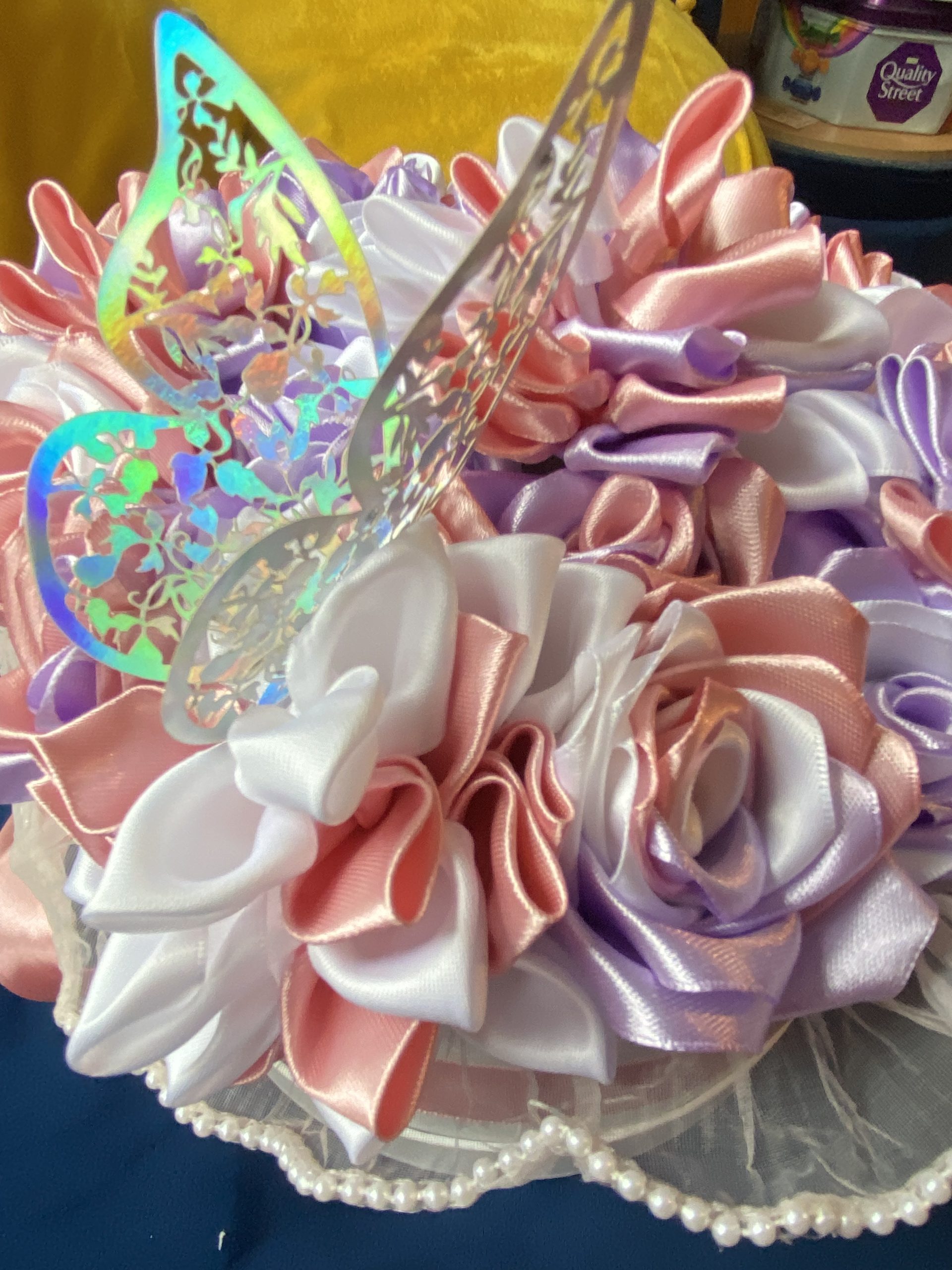 Medium sized round box of hand made ribbon flowers