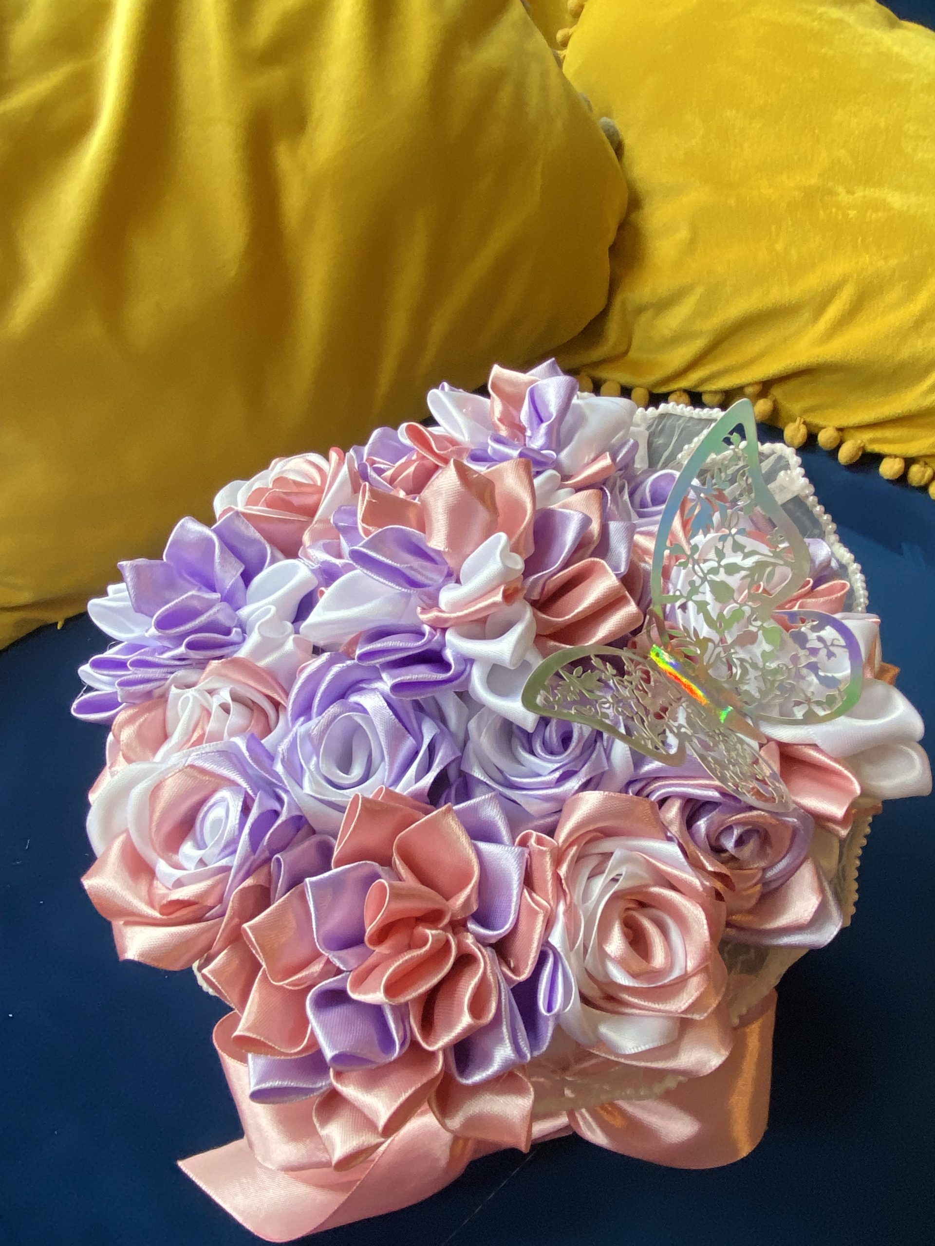 Medium sized round box of hand made ribbon flowers