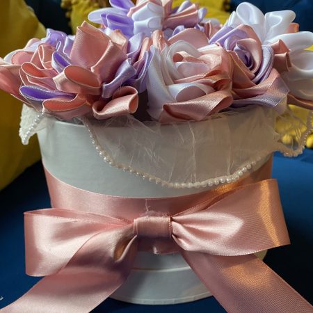 Medium sized round box of hand made ribbon flowers