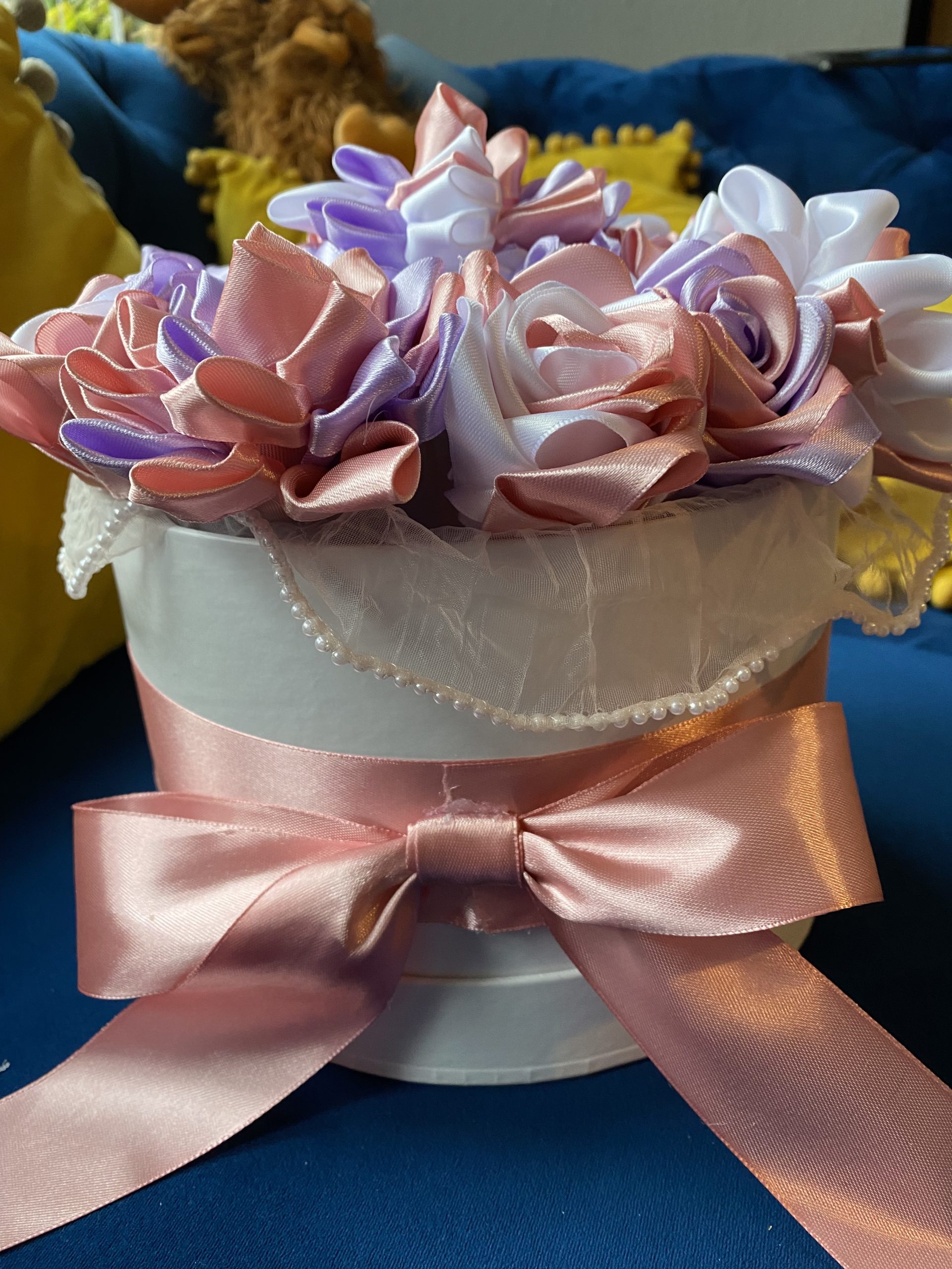 Medium sized round box of hand made ribbon flowers