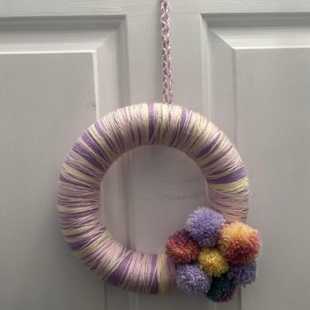 Handmade lilac, lemon and pink wool wrapped wreath with pompom flower
