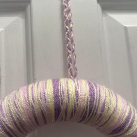 Handmade lilac, lemon and pink wool wrapped wreath with pompom flower