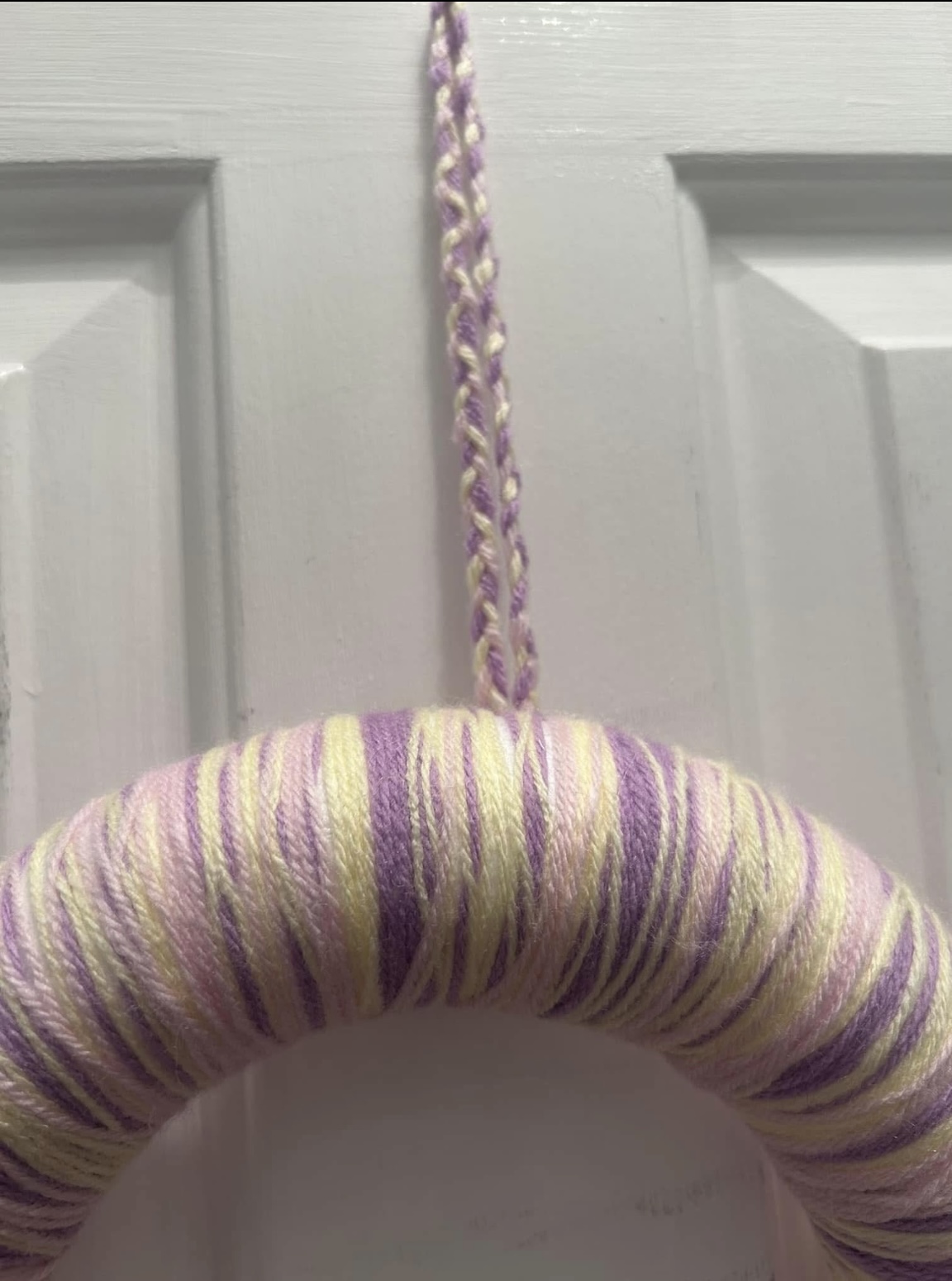 Handmade lilac, lemon and pink wool wrapped wreath with pompom flower