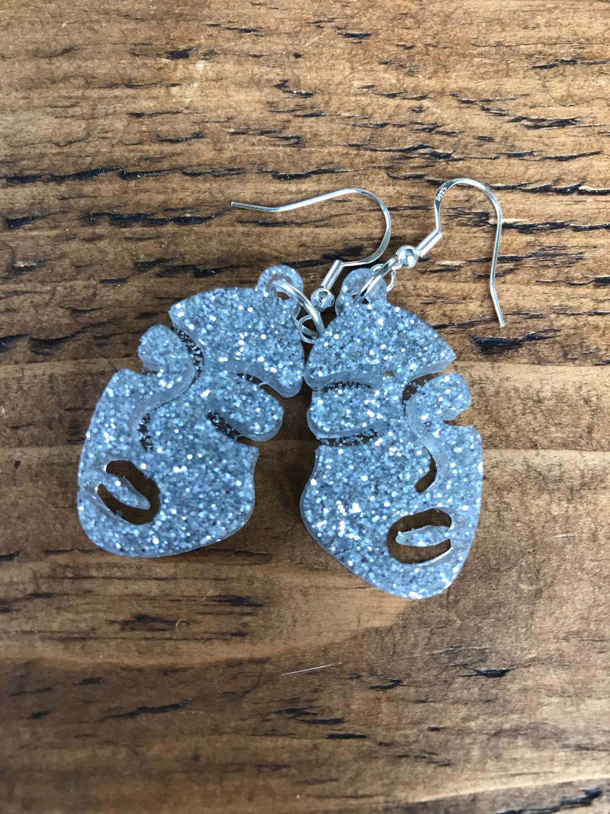 Glow in the dark face earrings