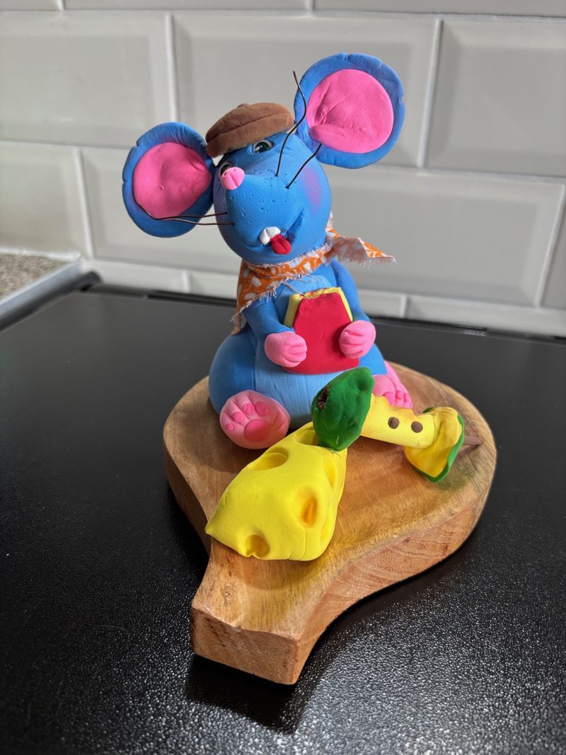 Handmade Cheeky Mouse eating Cheese and Apple made from Foam Clay on a Wooden Base
