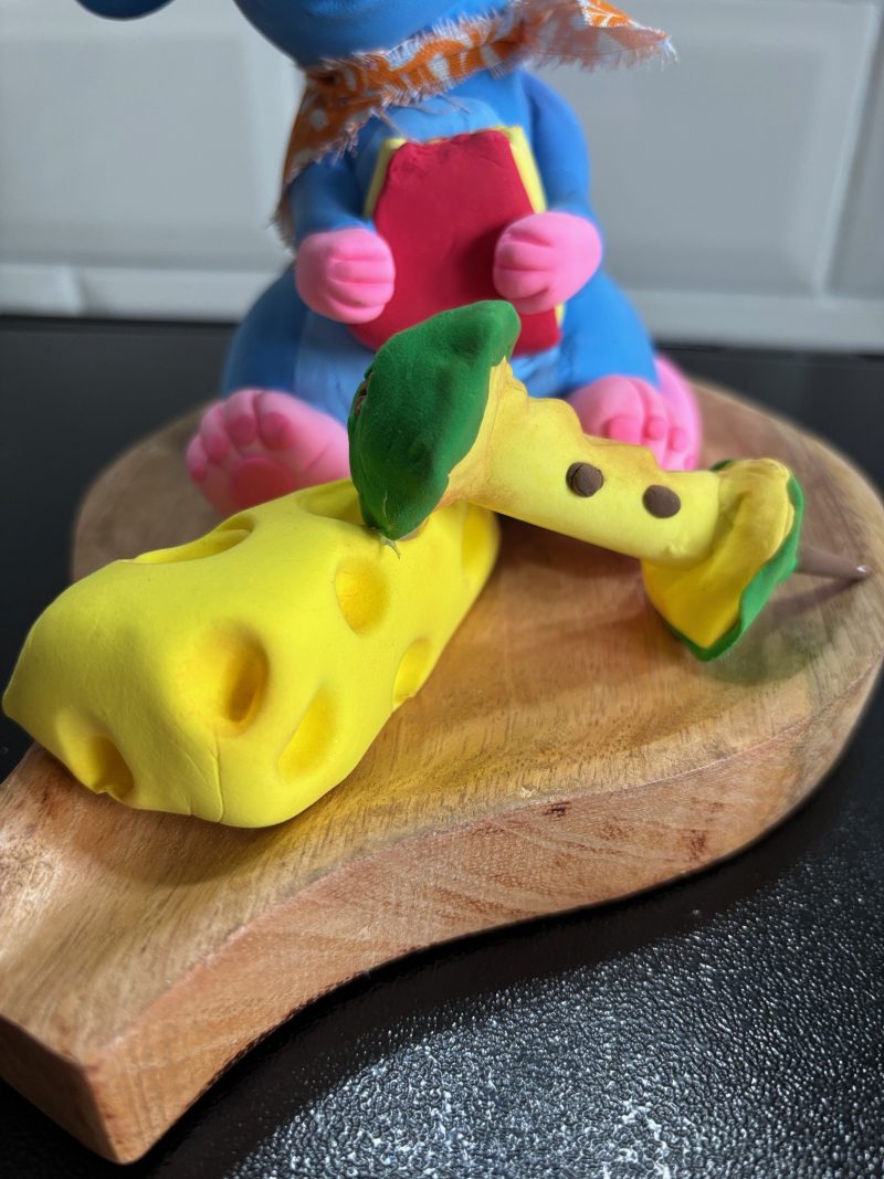 Handmade Cheeky Mouse eating Cheese and Apple made from Foam Clay on a Wooden Base