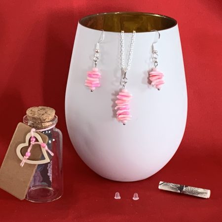Sterling silver earrings and necklace set with pink shells inside a message in a bottle
