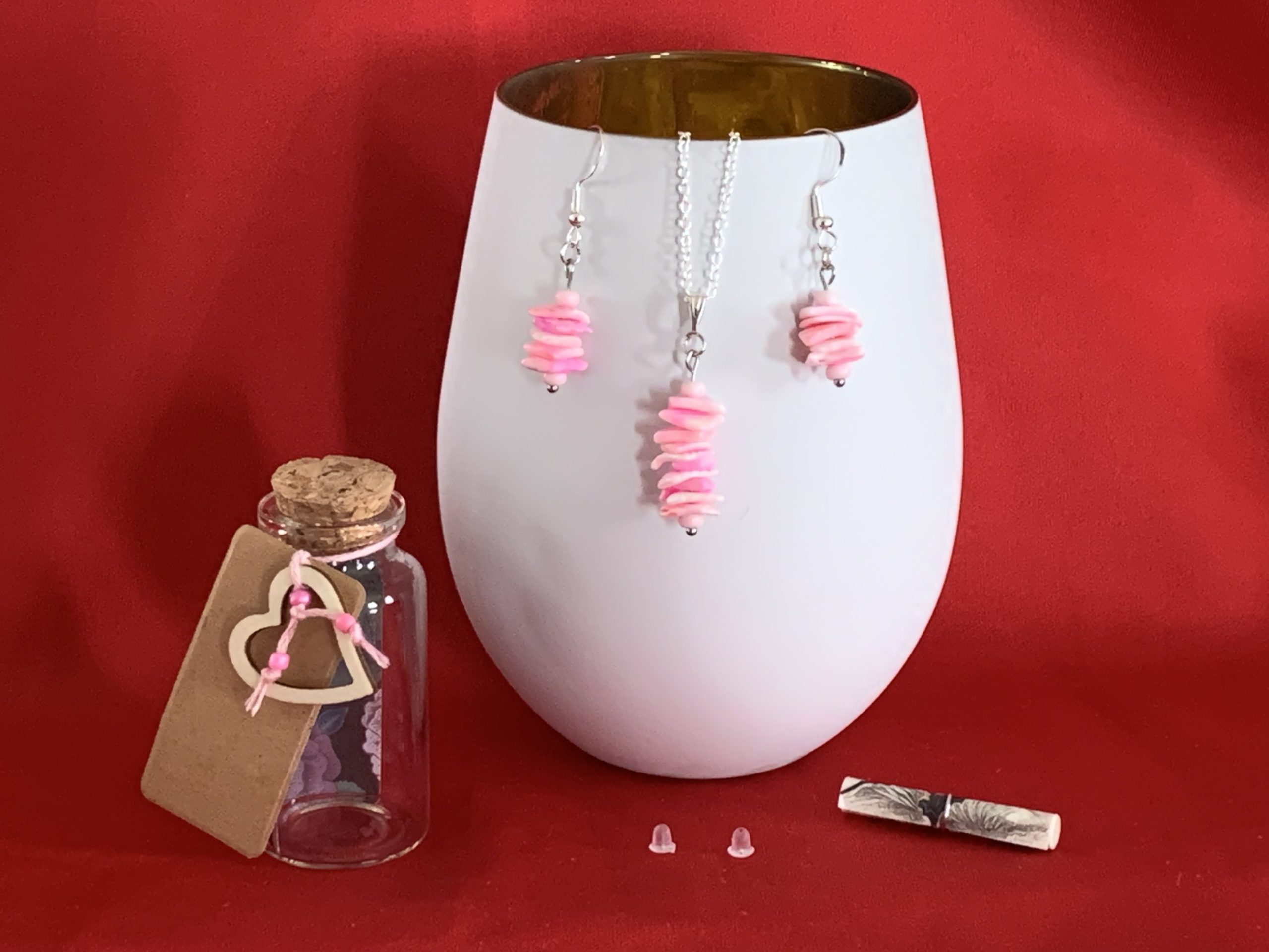 Sterling silver earrings and necklace set with pink shells inside a message in a bottle