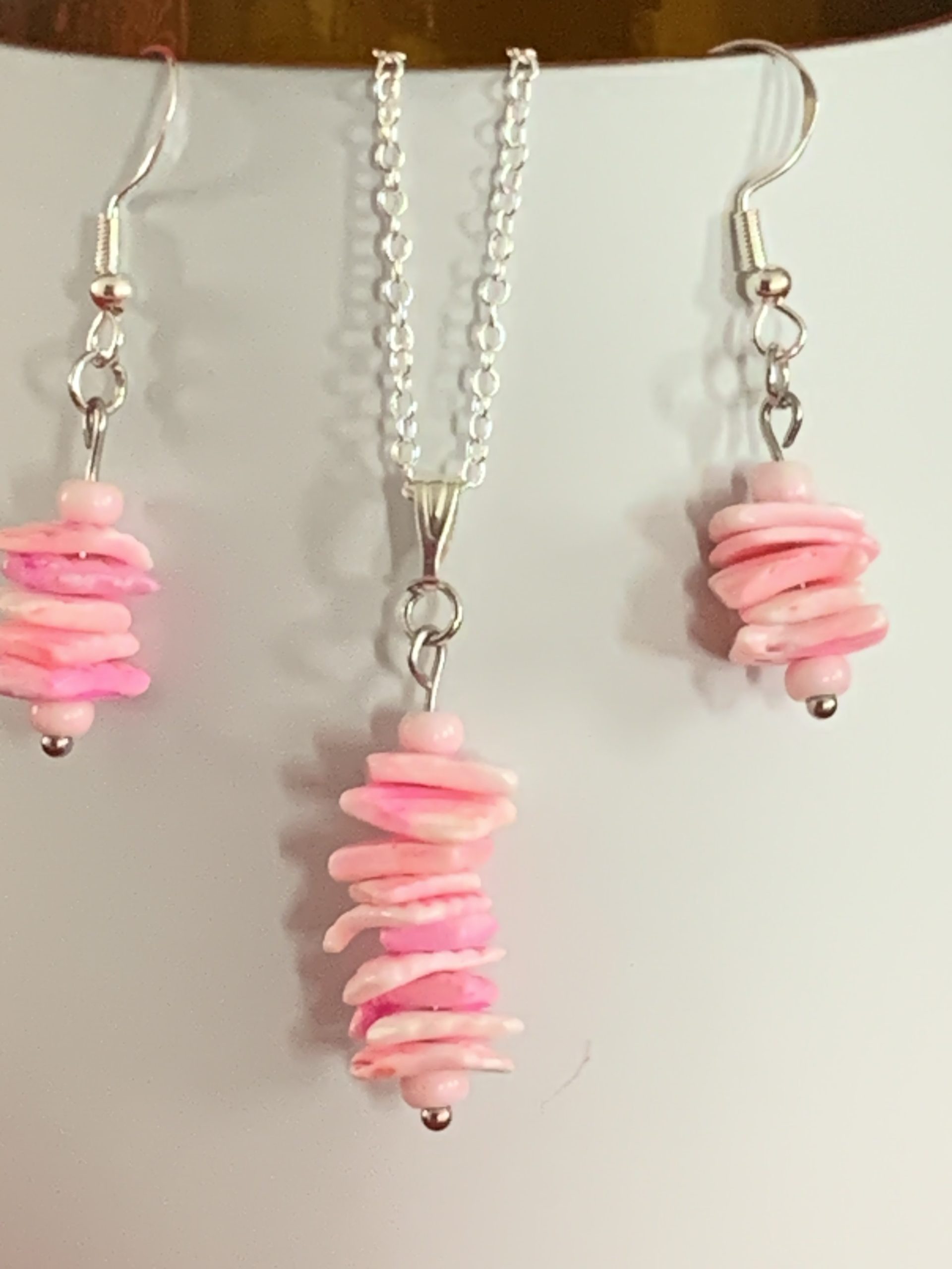 Sterling silver earrings and necklace set with pink shells inside a message in a bottle