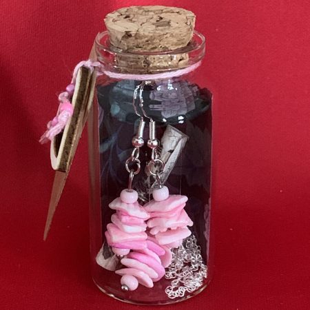 Sterling silver earrings and necklace set with pink shells inside a message in a bottle