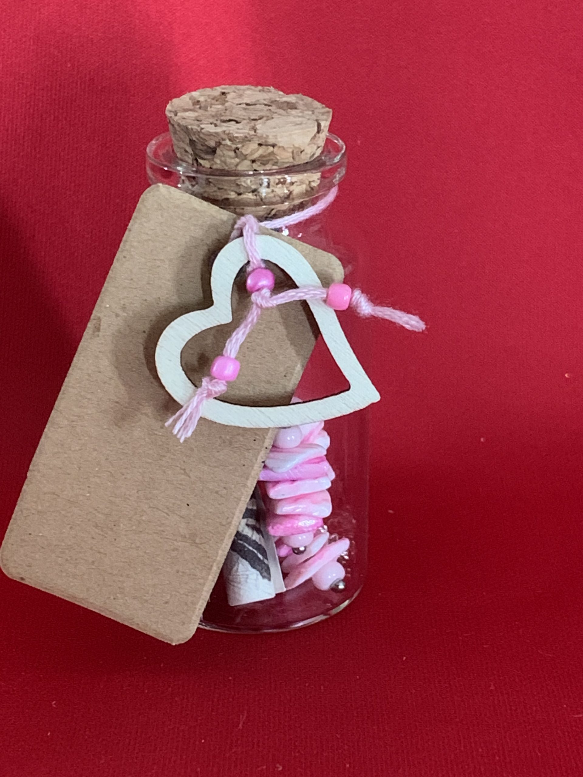 Sterling silver earrings and necklace set with pink shells inside a message in a bottle