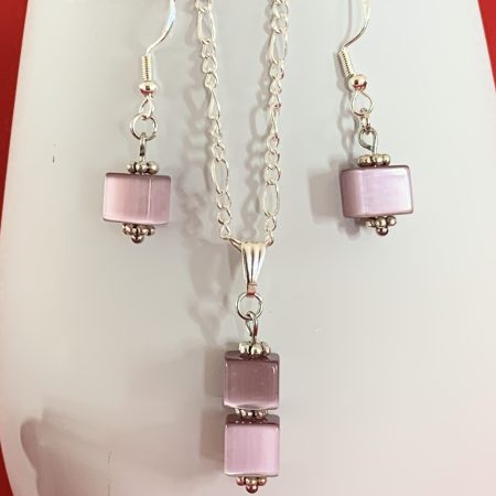 Sterling silver earrings and necklace set with purple squares inside a message in a bottle